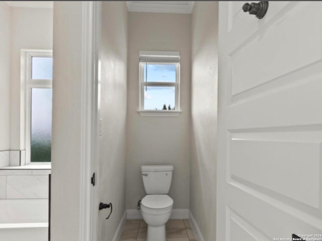 bathroom with crown molding, toilet, and tile patterned floors