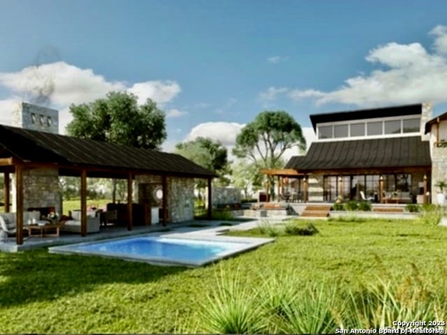 view of swimming pool featuring a lawn, an outdoor living space, and a patio area