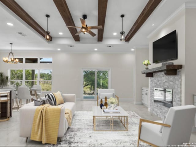 living room with ceiling fan with notable chandelier, a fireplace, crown molding, and beamed ceiling