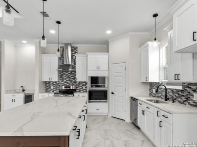 kitchen featuring white cabinets, stainless steel appliances, wall chimney exhaust hood, and sink