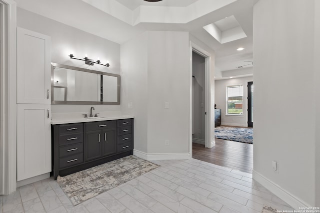 bathroom featuring vanity, ceiling fan, and wood-type flooring