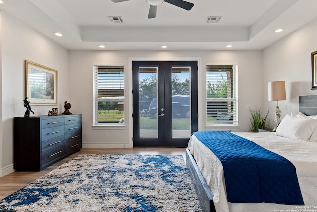 bedroom with access to exterior, ceiling fan, light wood-type flooring, and french doors