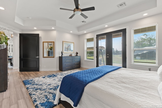 bedroom with light wood-type flooring, french doors, access to outside, and ceiling fan