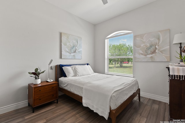 bedroom with dark wood-type flooring, ceiling fan, and vaulted ceiling