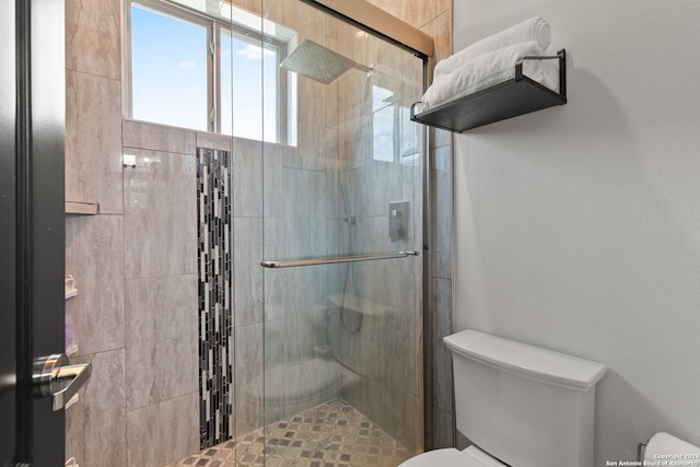 bathroom with walk in shower and toilet