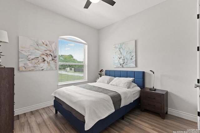 bedroom with lofted ceiling, wood-type flooring, and ceiling fan