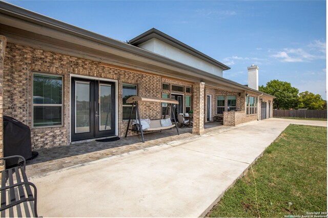 rear view of property with a yard and a patio