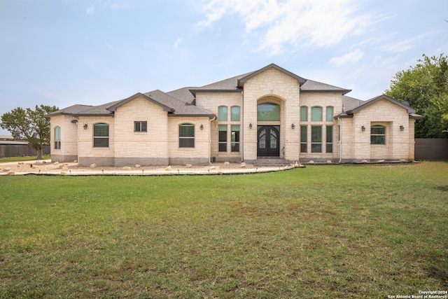 rear view of property with a yard