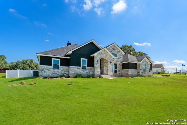 view of front of house featuring a front lawn and cooling unit