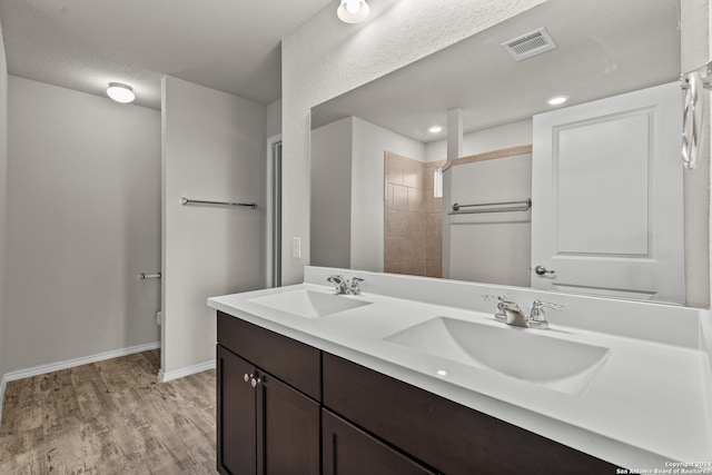 bathroom featuring vanity, a textured ceiling, and hardwood / wood-style floors