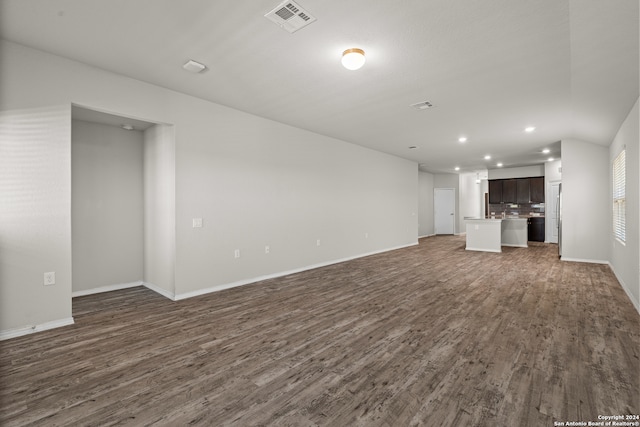 unfurnished living room with dark hardwood / wood-style floors