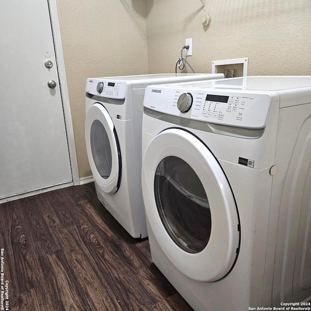 laundry area with separate washer and dryer and dark hardwood / wood-style flooring