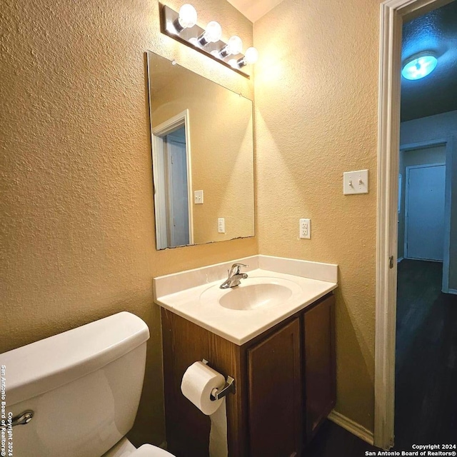 bathroom featuring vanity and toilet