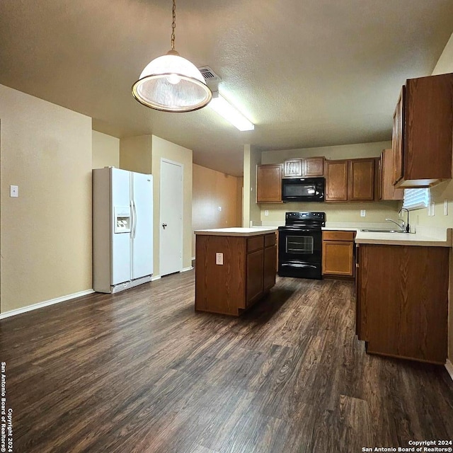 kitchen with hanging light fixtures, sink, black appliances, dark hardwood / wood-style floors, and a kitchen island