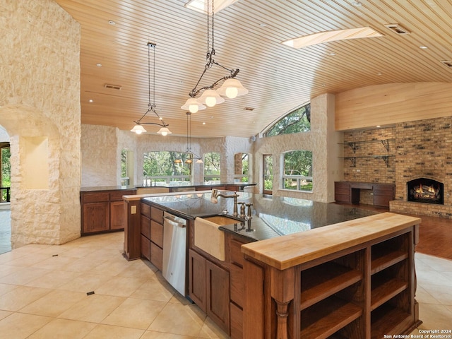 kitchen with a sink, wooden ceiling, plenty of natural light, and dishwasher