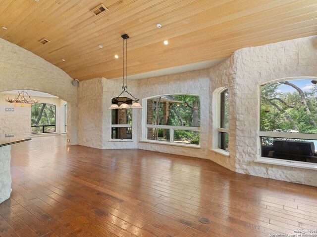 unfurnished living room featuring visible vents, high vaulted ceiling, arched walkways, wood-type flooring, and wood ceiling