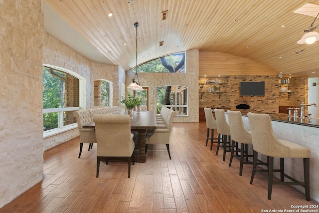 dining area featuring hardwood / wood-style floors, wooden ceiling, and high vaulted ceiling