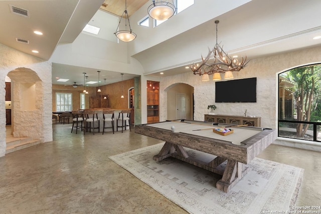 recreation room featuring arched walkways, a towering ceiling, billiards, and visible vents