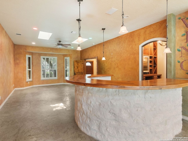interior space featuring visible vents, baseboards, hanging light fixtures, recessed lighting, and finished concrete floors