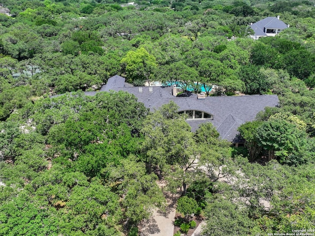 drone / aerial view featuring a forest view