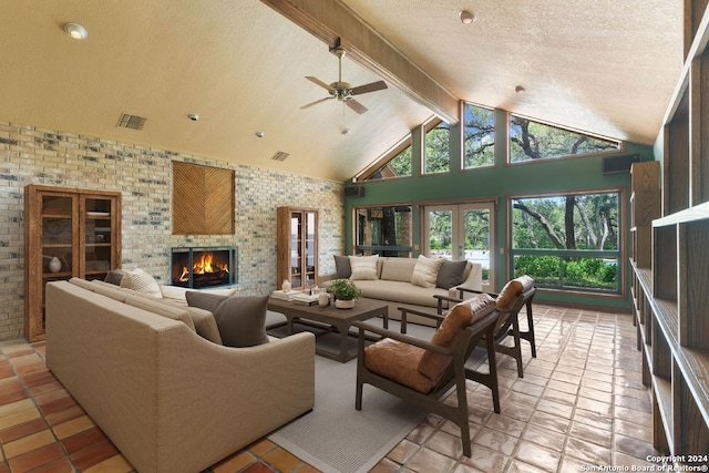 living room featuring a textured ceiling, a brick fireplace, beamed ceiling, ceiling fan, and high vaulted ceiling