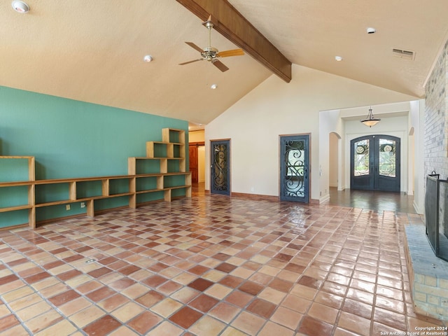 unfurnished living room featuring high vaulted ceiling, arched walkways, a ceiling fan, french doors, and beam ceiling