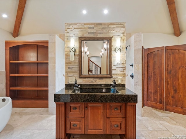 bathroom with a freestanding bath, recessed lighting, vanity, and vaulted ceiling with beams