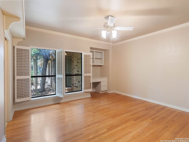 unfurnished living room with ornamental molding, light wood-style flooring, and baseboards