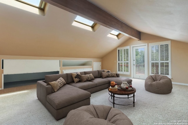 living room with carpet, lofted ceiling with skylight, and baseboards