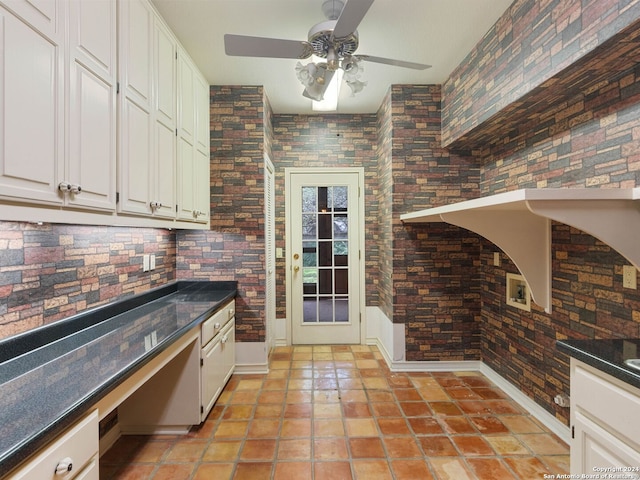 kitchen with ceiling fan, light tile patterned floors, white cabinets, dark countertops, and baseboards
