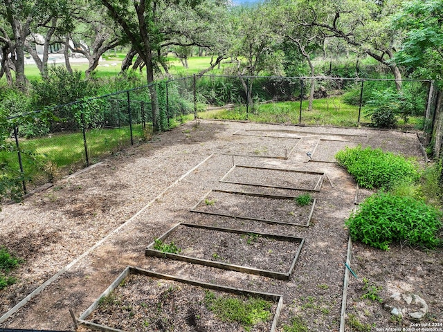 exterior space featuring fence and a vegetable garden