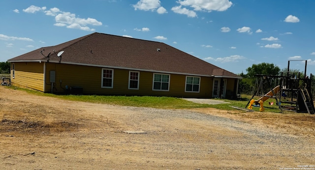 back of house featuring a playground