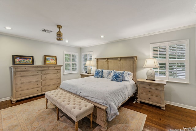 bedroom with multiple windows, dark wood-type flooring, crown molding, and ceiling fan