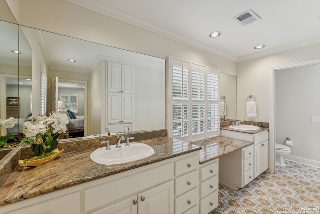 bathroom featuring vanity, toilet, and plenty of natural light