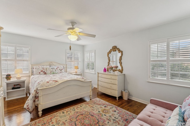 bedroom with dark hardwood / wood-style flooring and ceiling fan