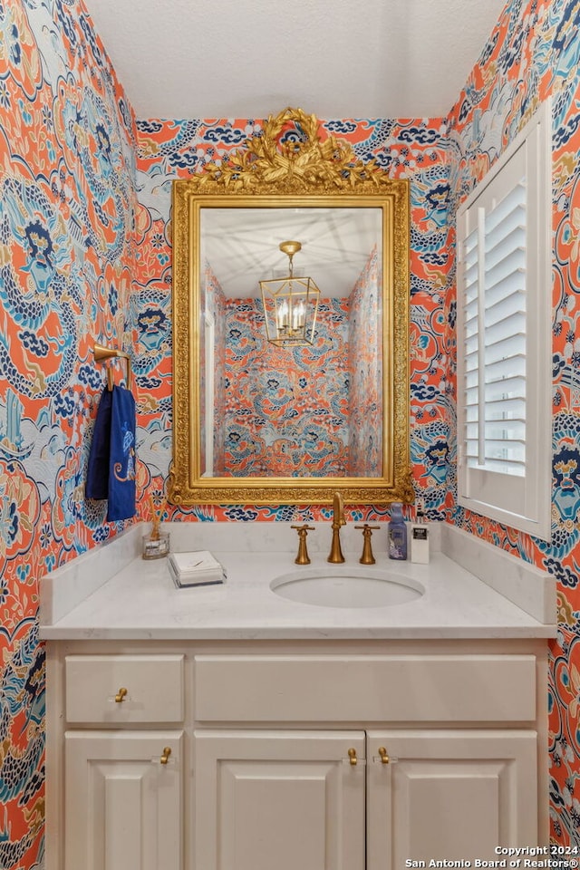 bathroom with vanity and an inviting chandelier