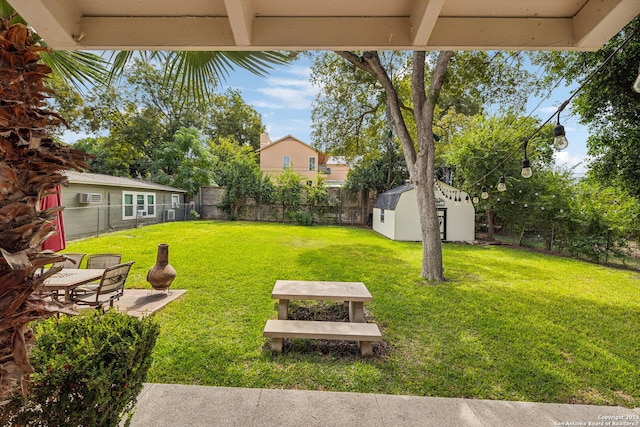 view of yard with a storage shed and a patio area