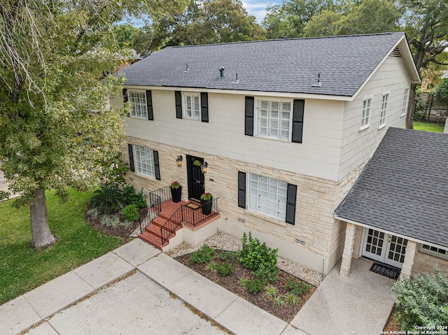 106 Morningside Dr, Terrell Hills, TX 78209 - view of front facade featuring a patio, a front yard, a shingled roof, and stone siding