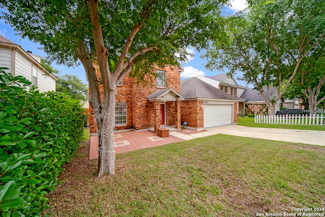 view of front of home with a garage and a front lawn