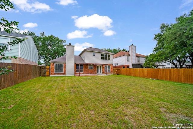 10314 Mustang Rdg, Converse, TX 78109 - back of house featuring brick siding, a patio area, and a chimney