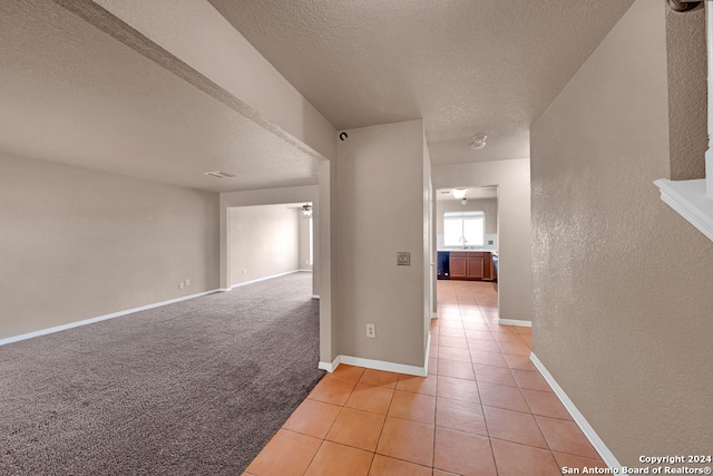 interior space with a textured ceiling and sink