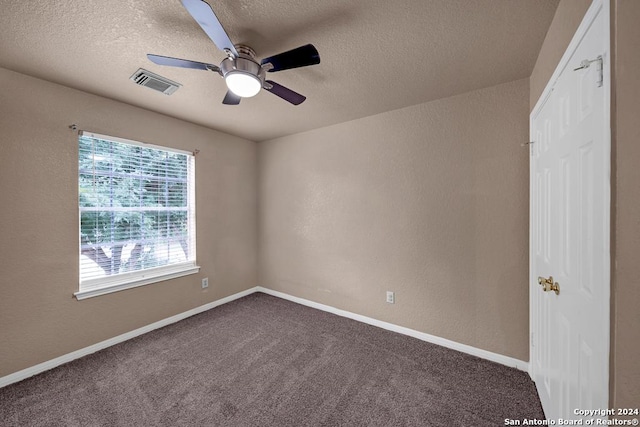 10314 Mustang Rdg, Converse, TX 78109 - empty room featuring ceiling fan, a textured ceiling, dark carpet, baseboards, and a textured wall