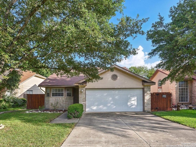 single story home with a front yard and a garage