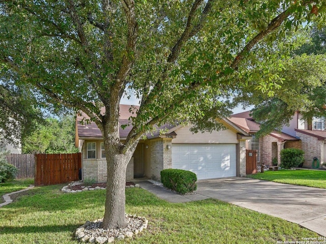 view of front of house with a garage and a front lawn