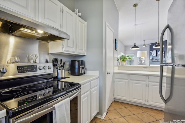 kitchen featuring hanging light fixtures, stainless steel appliances, white cabinetry, and light tile patterned flooring