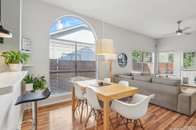 dining area featuring light wood-type flooring, ceiling fan, and plenty of natural light