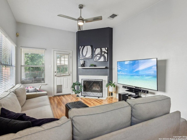 living room with wood-type flooring and ceiling fan