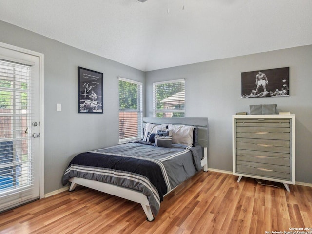 bedroom with light hardwood / wood-style floors and access to exterior