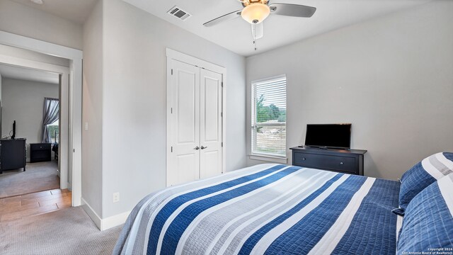 bedroom featuring a closet, ceiling fan, and carpet floors