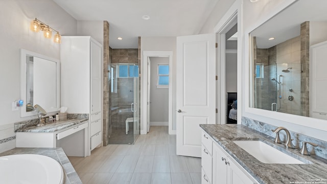 bathroom with tile patterned flooring, separate shower and tub, and vanity